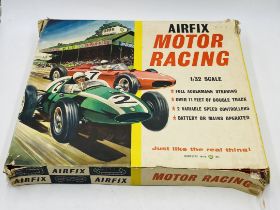 A boxed vintage 1960's Airfix Motor Racing set (1:32 scale) including two cars, barriers,