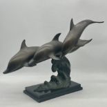 A copper statue of three leaping dolphins. Approx measurements height 48cm, length 70cm
