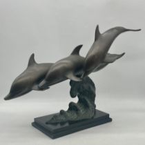 A copper statue of three leaping dolphins. Approx measurements height 48cm, length 70cm