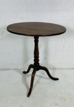 An antique oval mahogany tripod table, base loose but secure