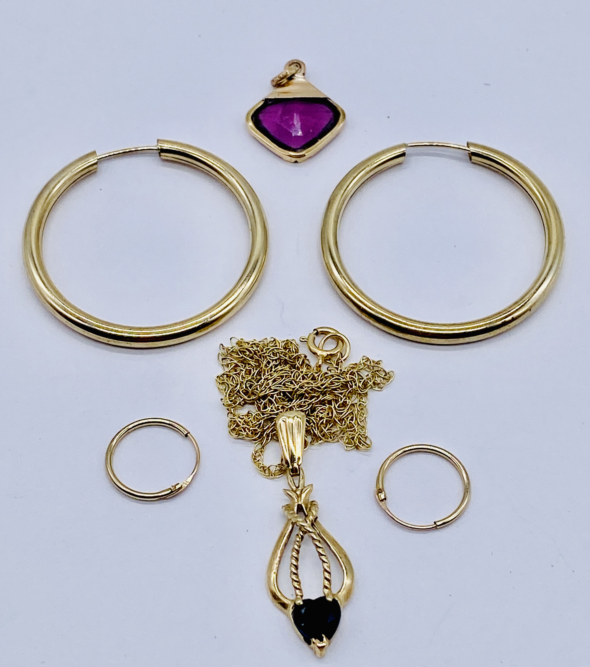 Two pairs of unmarked gold hoop earrings (weight 1.7g) a 9ct gold fine chain (0.8g) with two