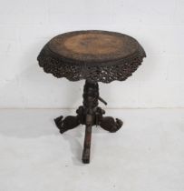 An Anglo Indian heavily carved and pierced circular hardwood table, raised on tripod base with