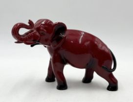 A Royal Doulton Flambe elephant with raised trunk signed by Michael Doulton in gold to the base