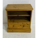 A freestanding pine unit with shelf and single drawer.