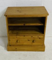 A freestanding pine unit with shelf and single drawer.