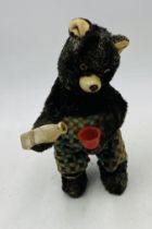 A vintage Japanese wind-up mechanical toy bear who pours and drinks - height approx. 21cm