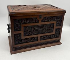 A turn of the century carved mahogany stationary box fitted with fold out writing slope, fitted