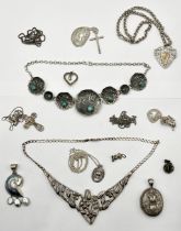 A collection of silver pendants, locket, medallion etc.