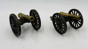 A pair of vintage cast iron and brass table top canons