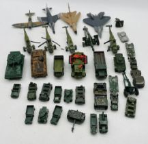 A collection of playworn die-cast military vehicles including tanks, helicopters, fighter jets,