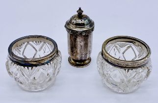 A hallmarked silver pepperette along with a pair of silver mounted glass salts