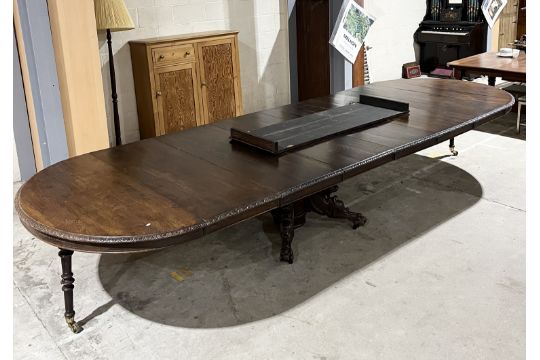 A large continental 19th century oak extending dining table the ends of circular form, raised on a - Image 3 of 14