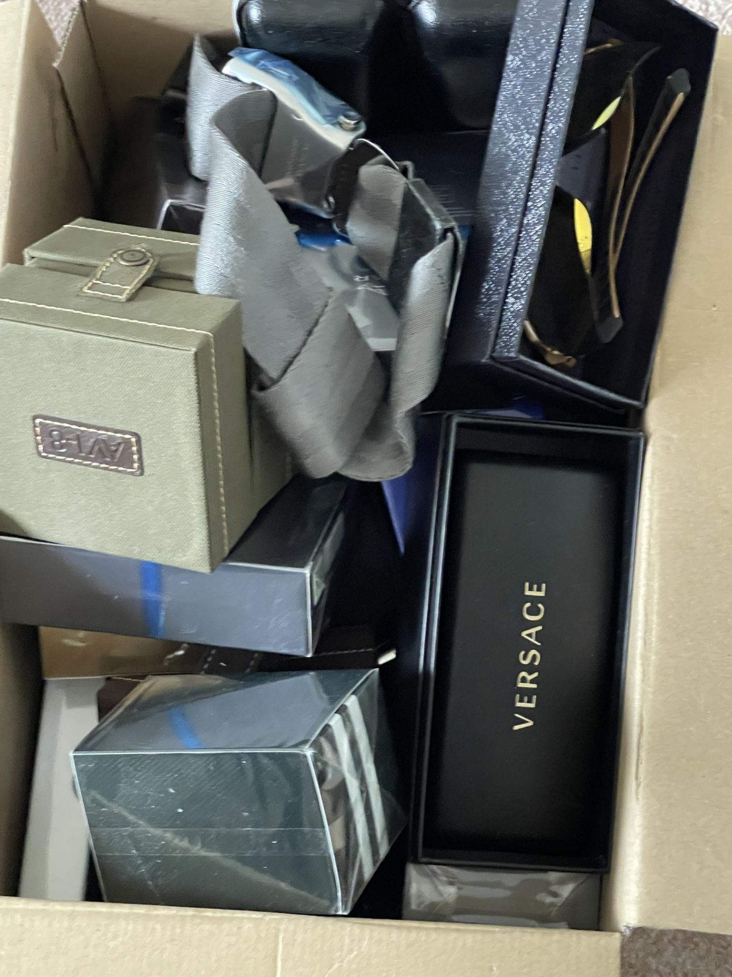 Aftershaves mystery box containing watches sunglasses ect worth