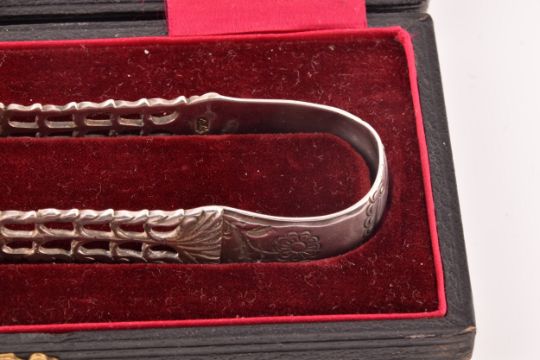 A pair of Georgian cast silver sugar tongs, by Richard Mills, crest engraved, featuring floral - Image 4 of 7