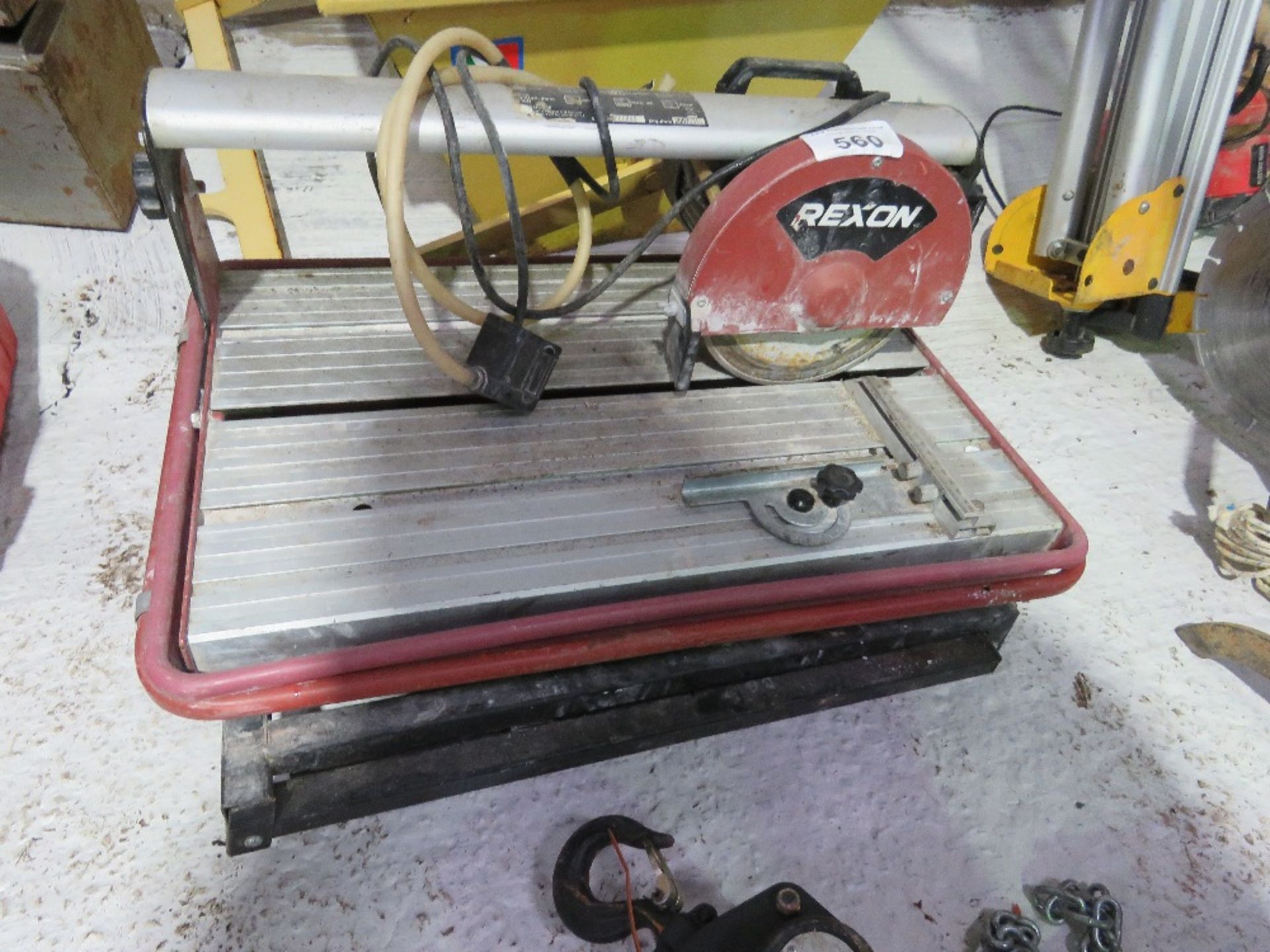 REXON SLIDING HEAD TILE SAW ON LEGS. DIRECT FROM LOCAL RETIRING BUILDER. THIS LOT IS SOLD UNDER