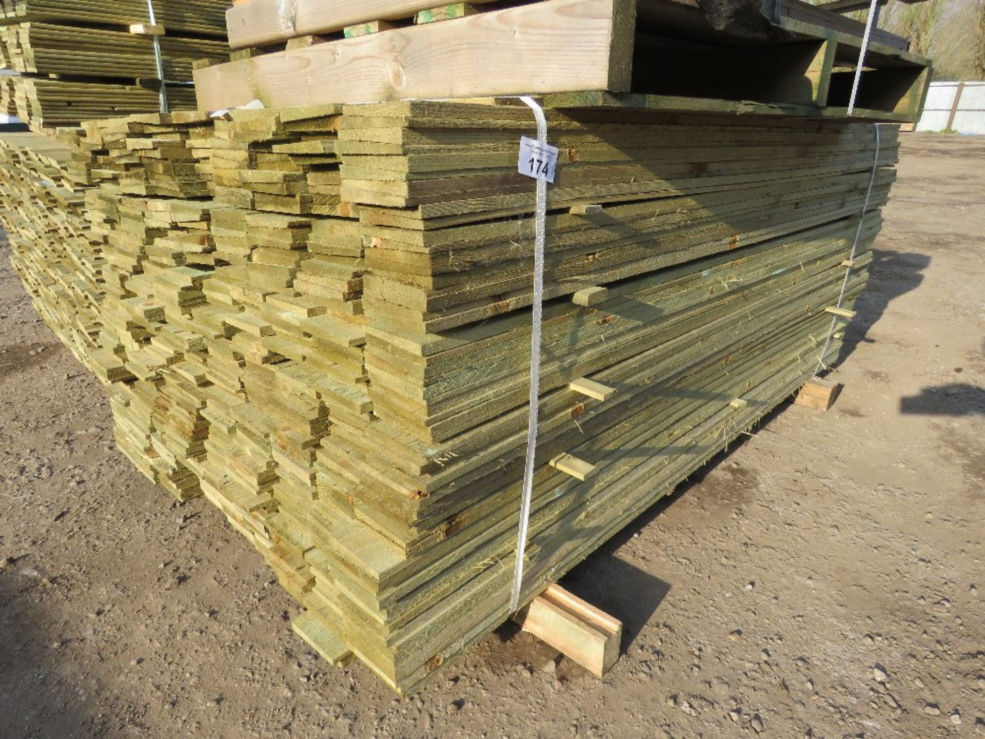 LARGE PACK OF TREATED FEATHER EDGE TIMBER CLADDING BOARDS 1.8M LENGTH X 100MM WIDTH APPROX.