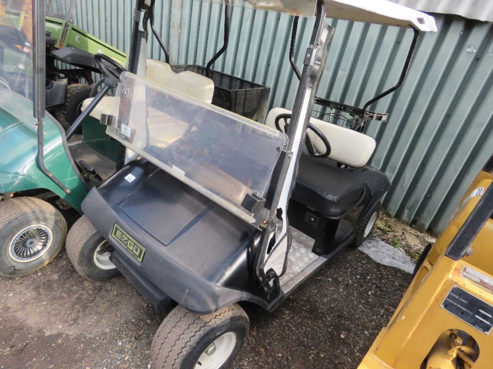 EZGO PETROL ENGINED GOLF BUGGY. BLACK COLOURED. WHEN TESTED WAS SEEN TO RUN, DRIVE, STEER AND BRAKE.