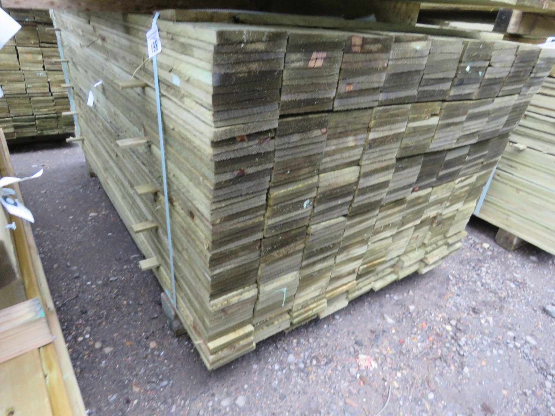 LARGE PACK OF TREATED FEATHER EDGE FENCE CLADDING TIMBER BOARDS. 1.65M LENGTH X 100MM WIDTH APPROX.