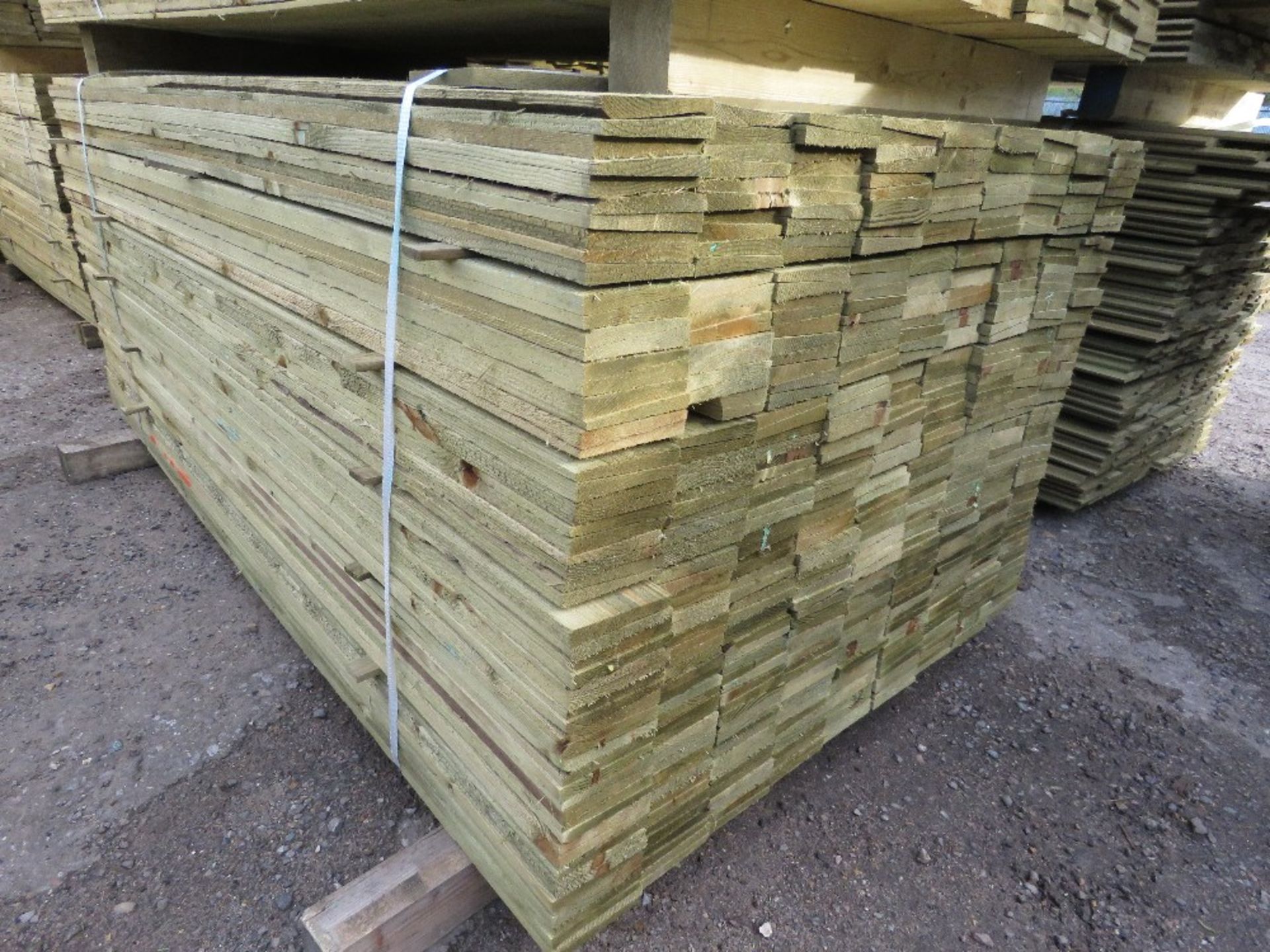 LARGE PACK OF PRESSURE TREATED FEATHER EDGE TIMBER CLADDING BOARDS. 1.80M LENGTH X 100MM WIDTH APPRO