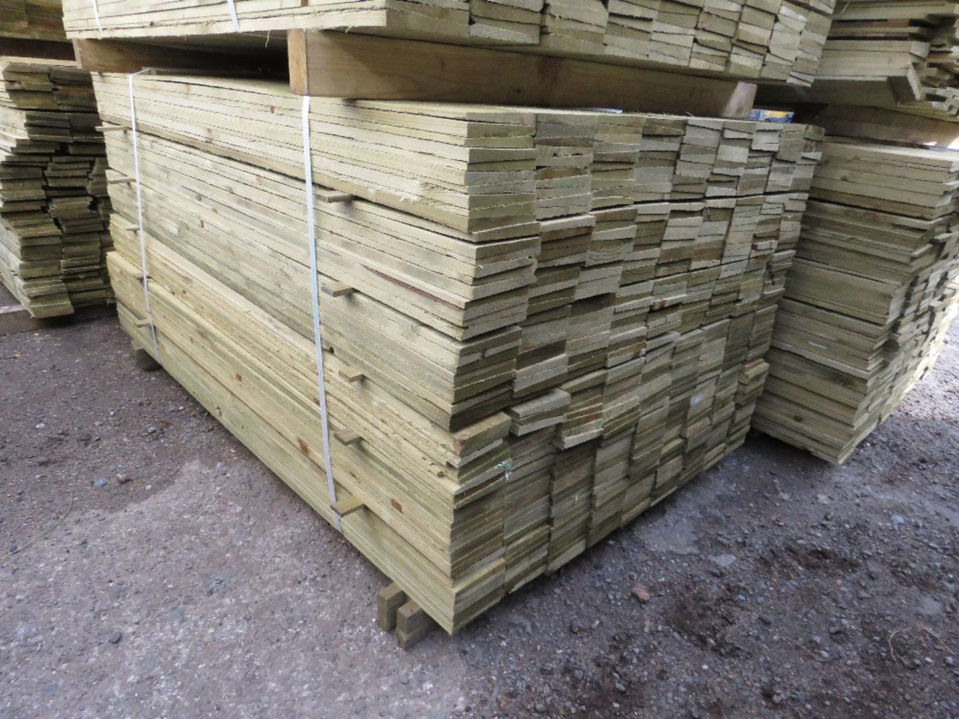 LARGE PACK OF PRESSURE TREATED FEATHER EDGE TIMBER CLADDING BOARDS. 1.50M LENGTH X 100MM WIDTH APPRO