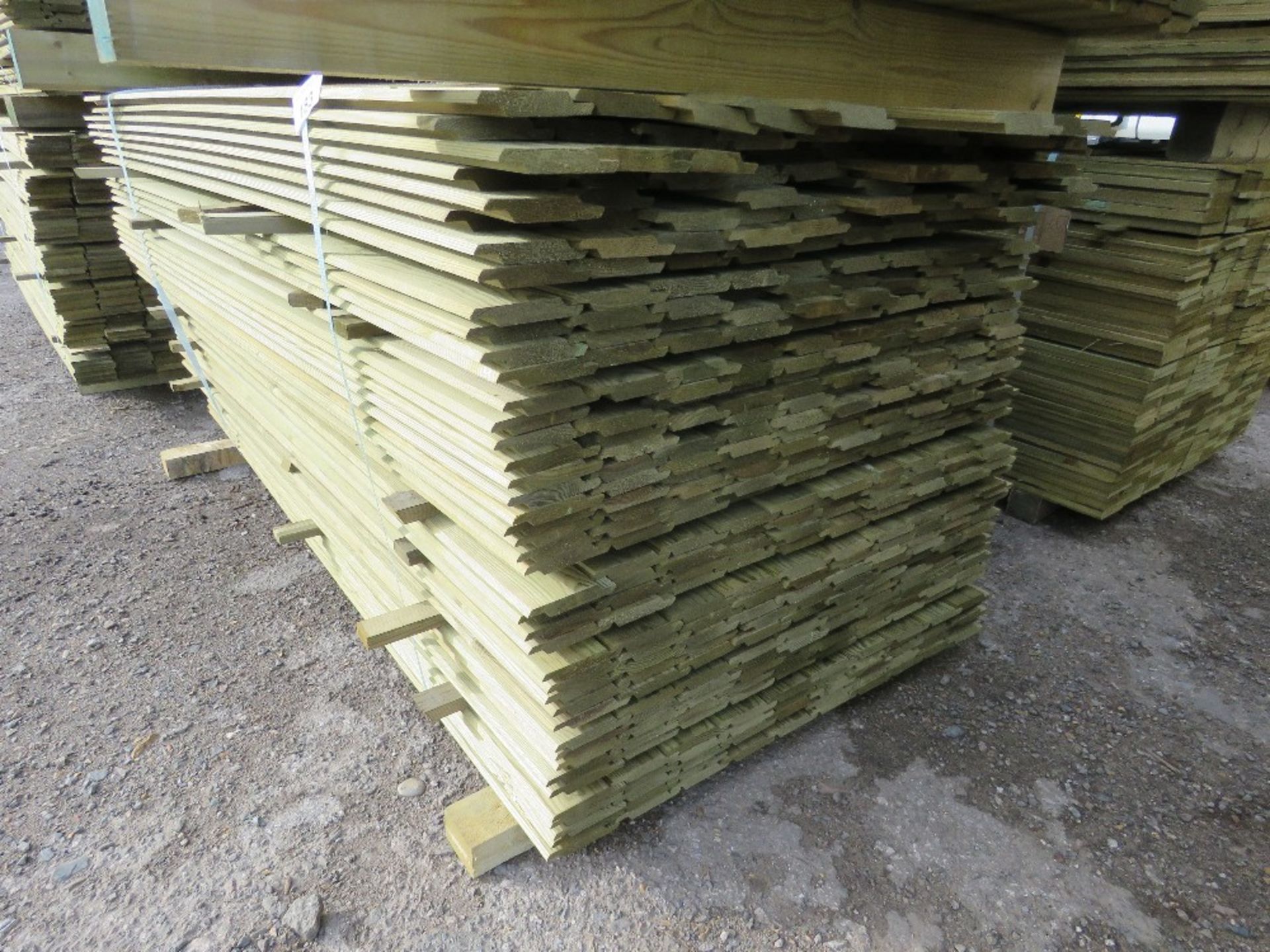 LARGE PACK OF PRESSURE TREATED SHIPLAP TYPE TIMBER CLADDING BOARDS. 1.73-1.93M LENGTH X 100MM WIDTH