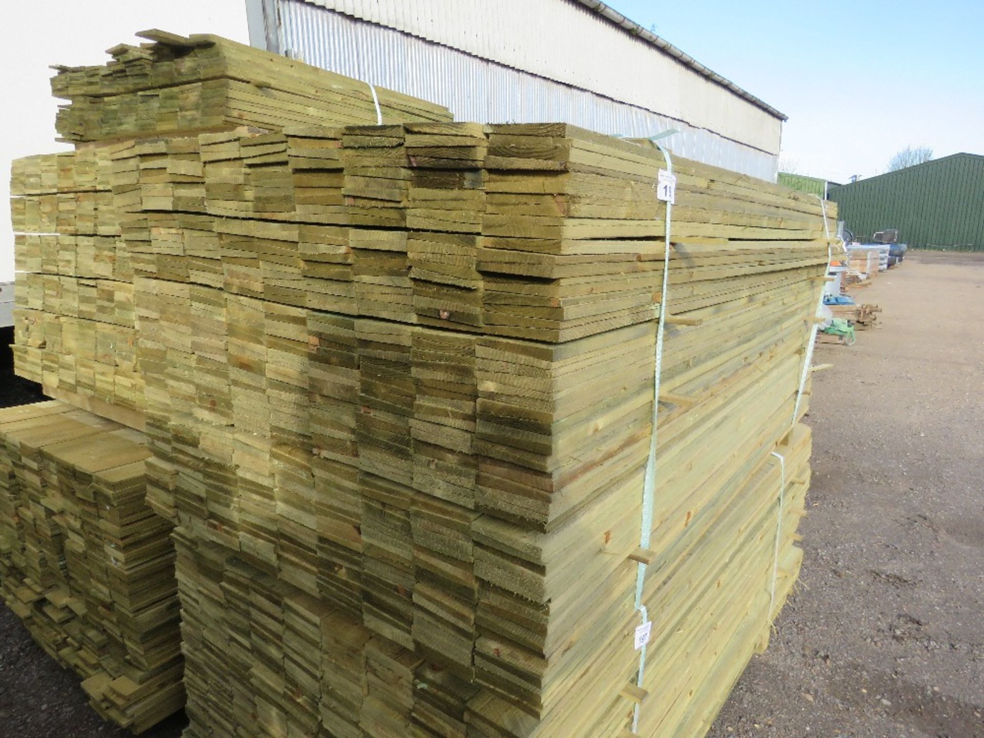 LARGE PACK OF PRESSURE TREATED FEATHER EDGE TIMBER CLADDING BOARDS. 1.80M LENGTH X 100MM WIDTH APPRO