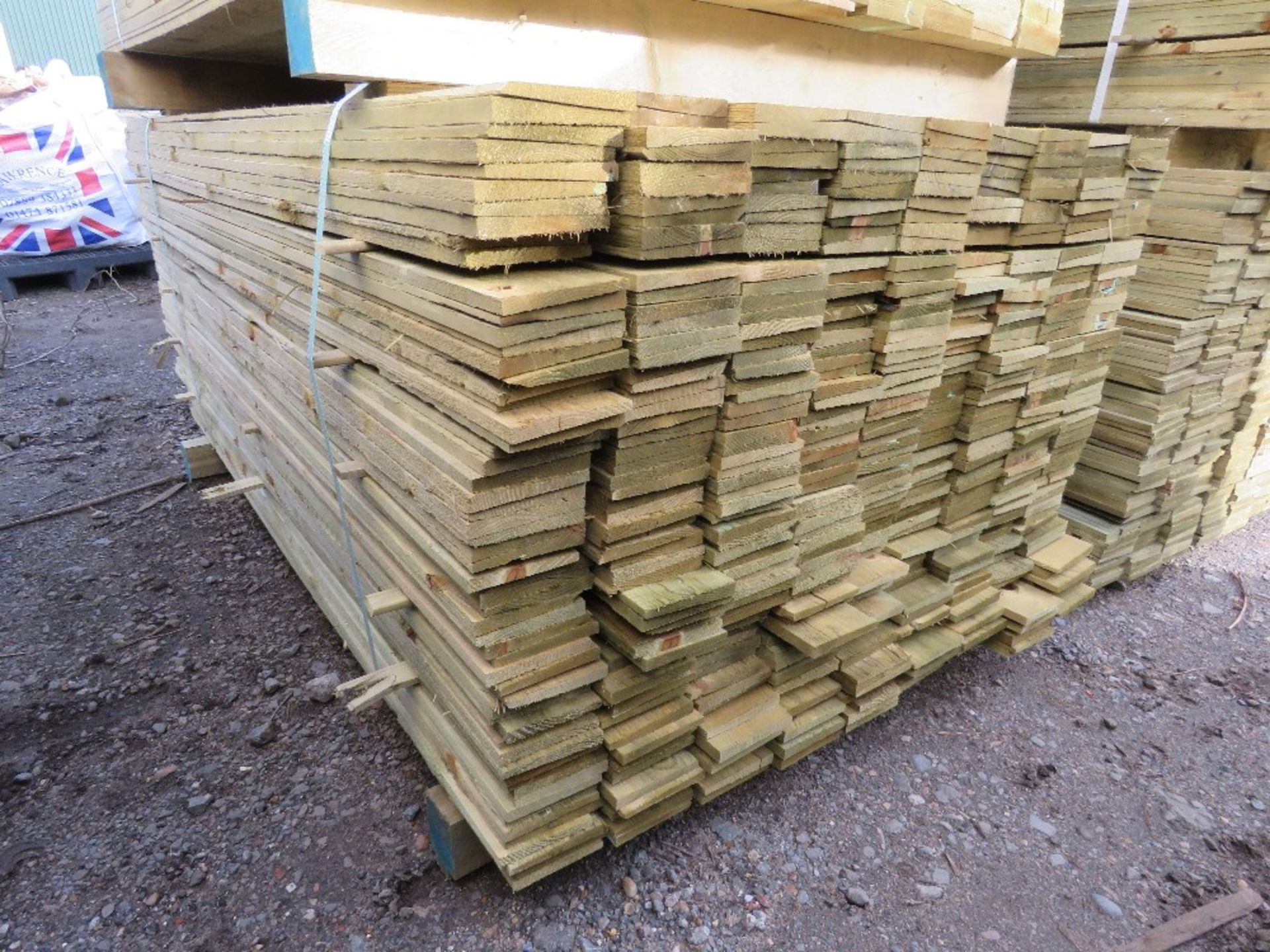 LARGE PACK OF PRESSURE TREATED FEATHER EDGE TIMBER CLADDING BOARDS. 1.80M LENGTH X 100MM WIDTH APPRO