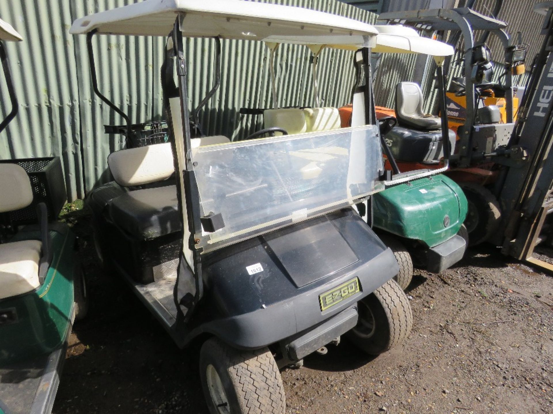 EZGO PETROL ENGINED GOLF BUGGY. BLACK COLOURED. WHEN TESTED WAS SEEN TO RUN, DRIVE, STEER AND BRAKE.