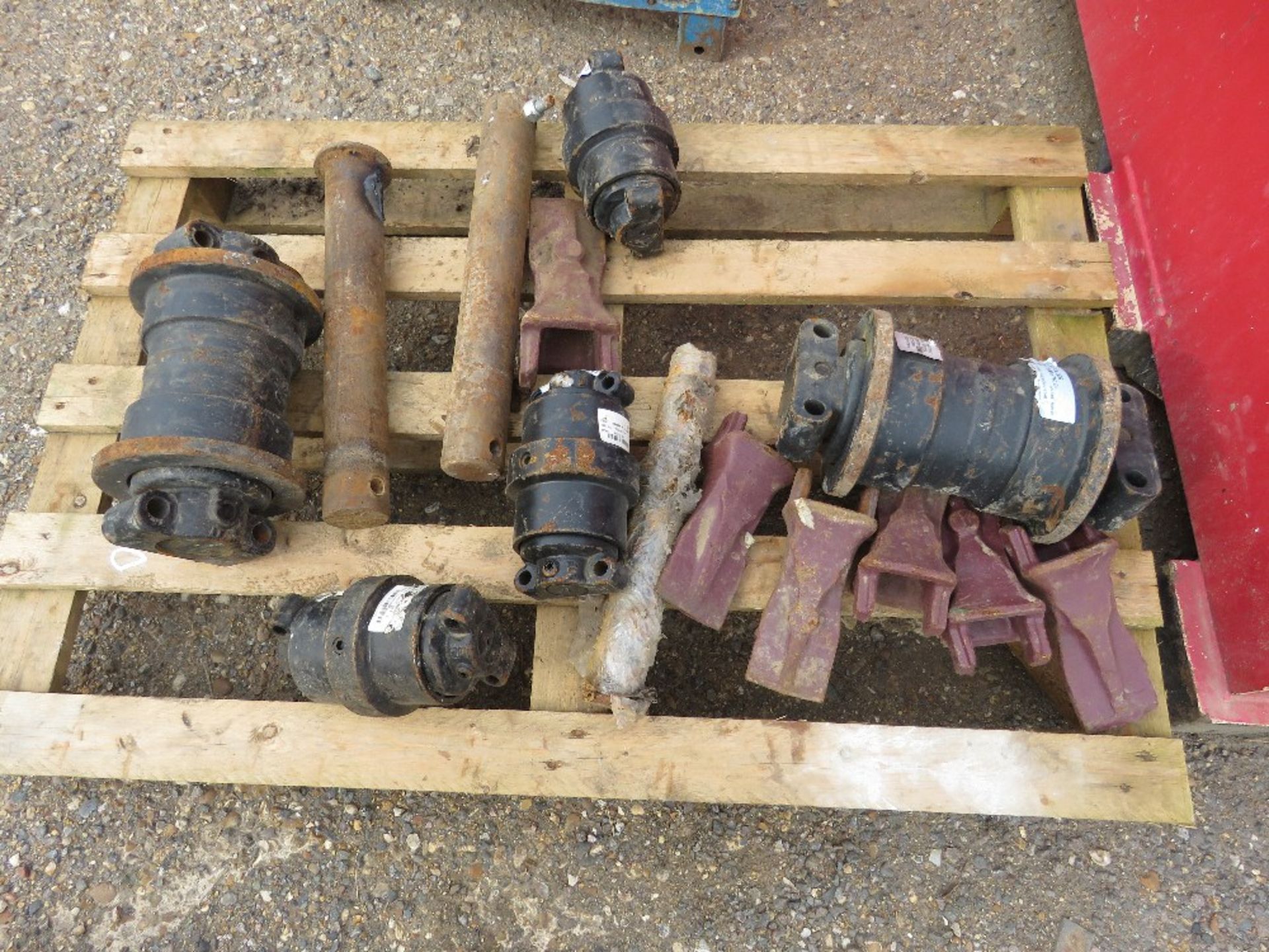 ASSORTED EXCAVATOR TRACK ROLLERS PLUS BUCKET TEETH AND PINS ETC......THIS LOT IS SOLD UNDER THE AUCT