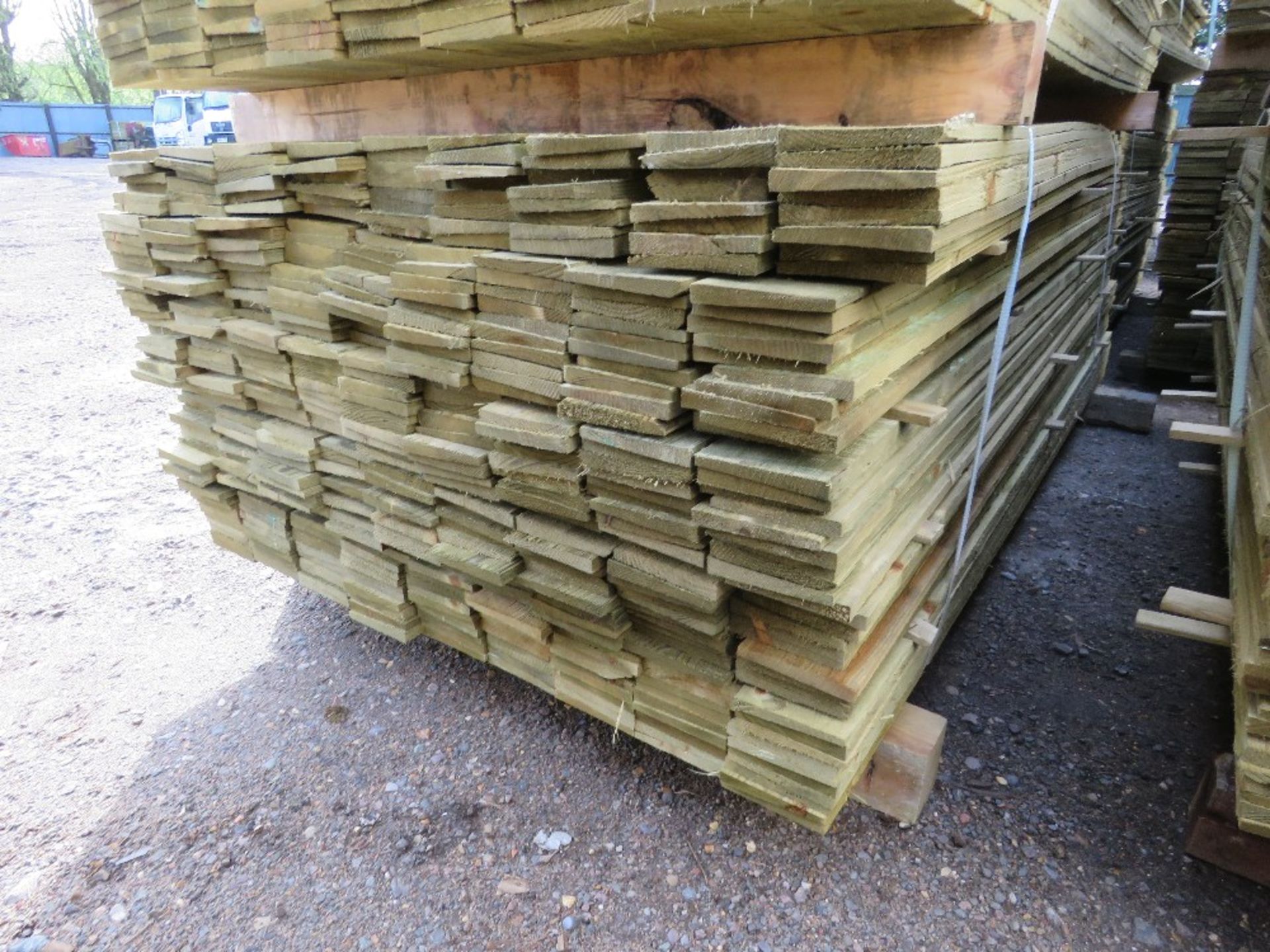 LARGE PACK OF PRESSURE TREATED FEATHER EDGE TIMBER CLADDING BOARDS. 1.80M LENGTH X 100MM WIDTH APPRO