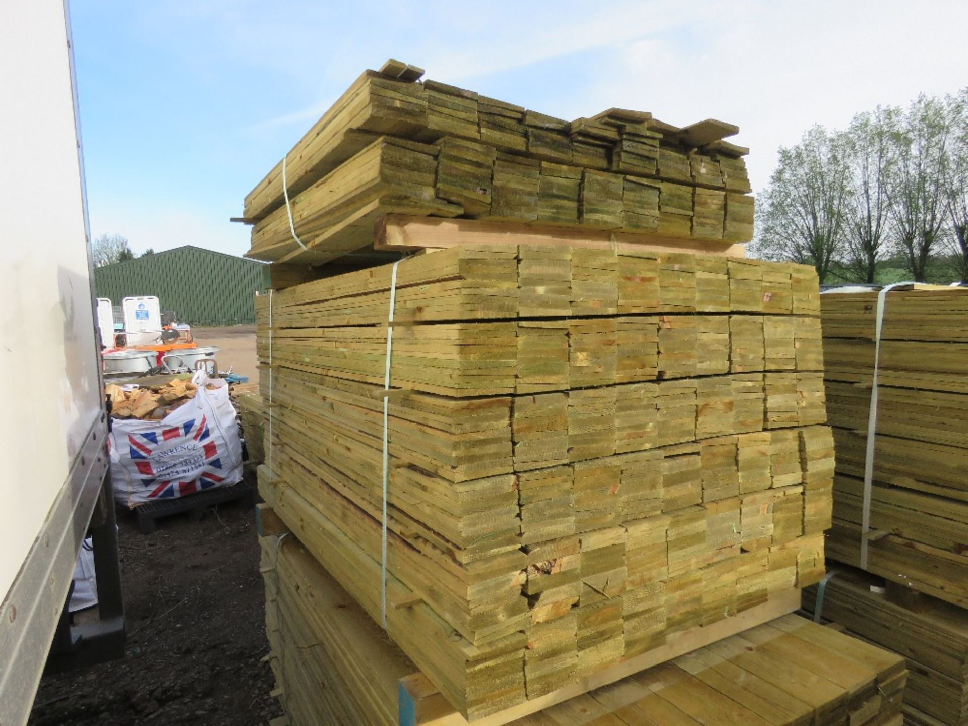 LARGE PACK OF PRESSURE TREATED FEATHER EDGE TIMBER CLADDING BOARDS. 1.5M LENGTH X 100MM WIDTH APPROX