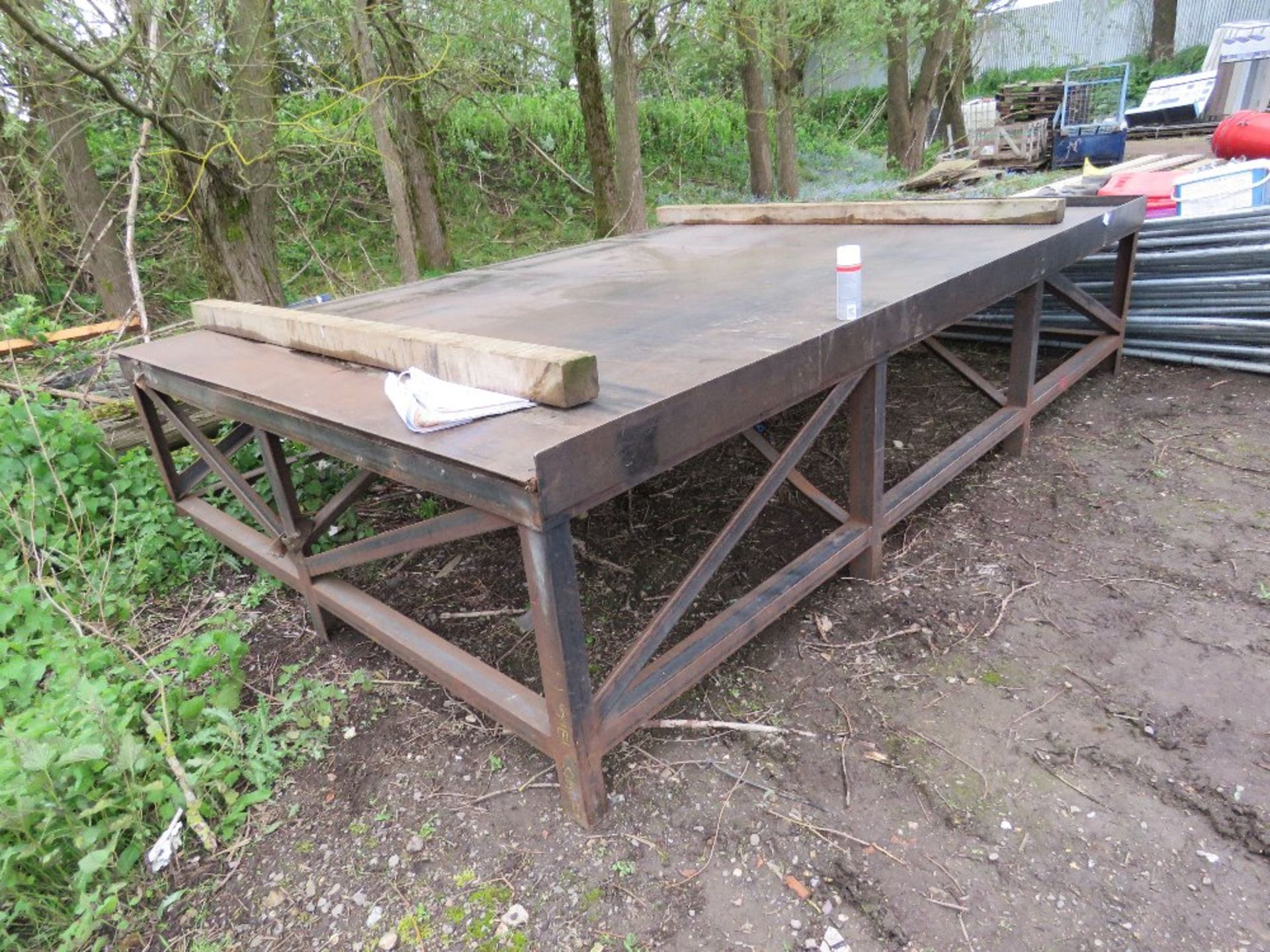 EXTRA LARGE HEAVY DUTY STEEL FACED WORK TABLE. 12FT X 8FT APPROX WITH WORK HEIGHT OF 0.85M APPROX.
