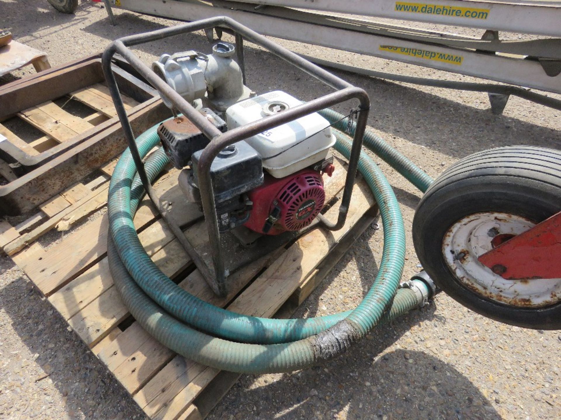 PETROL ENGINED WATER PUMP WITH HOSE.