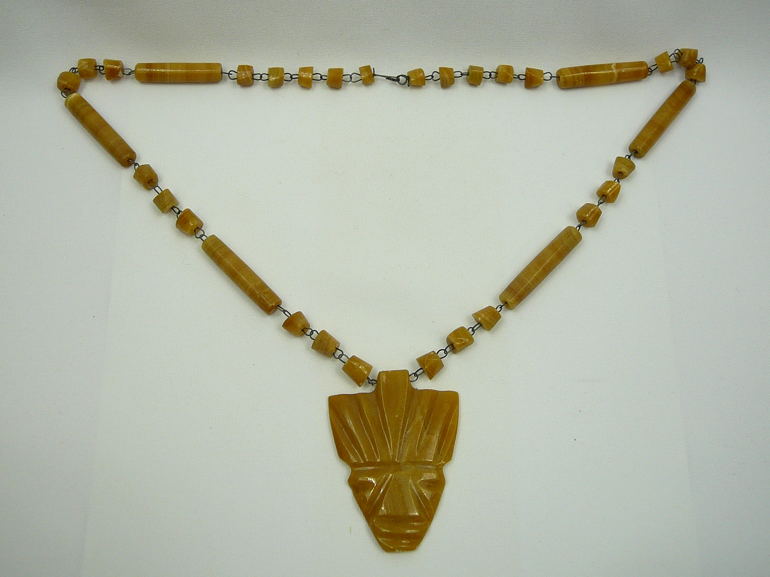 Carved Stone Mask And Beaded Necklace