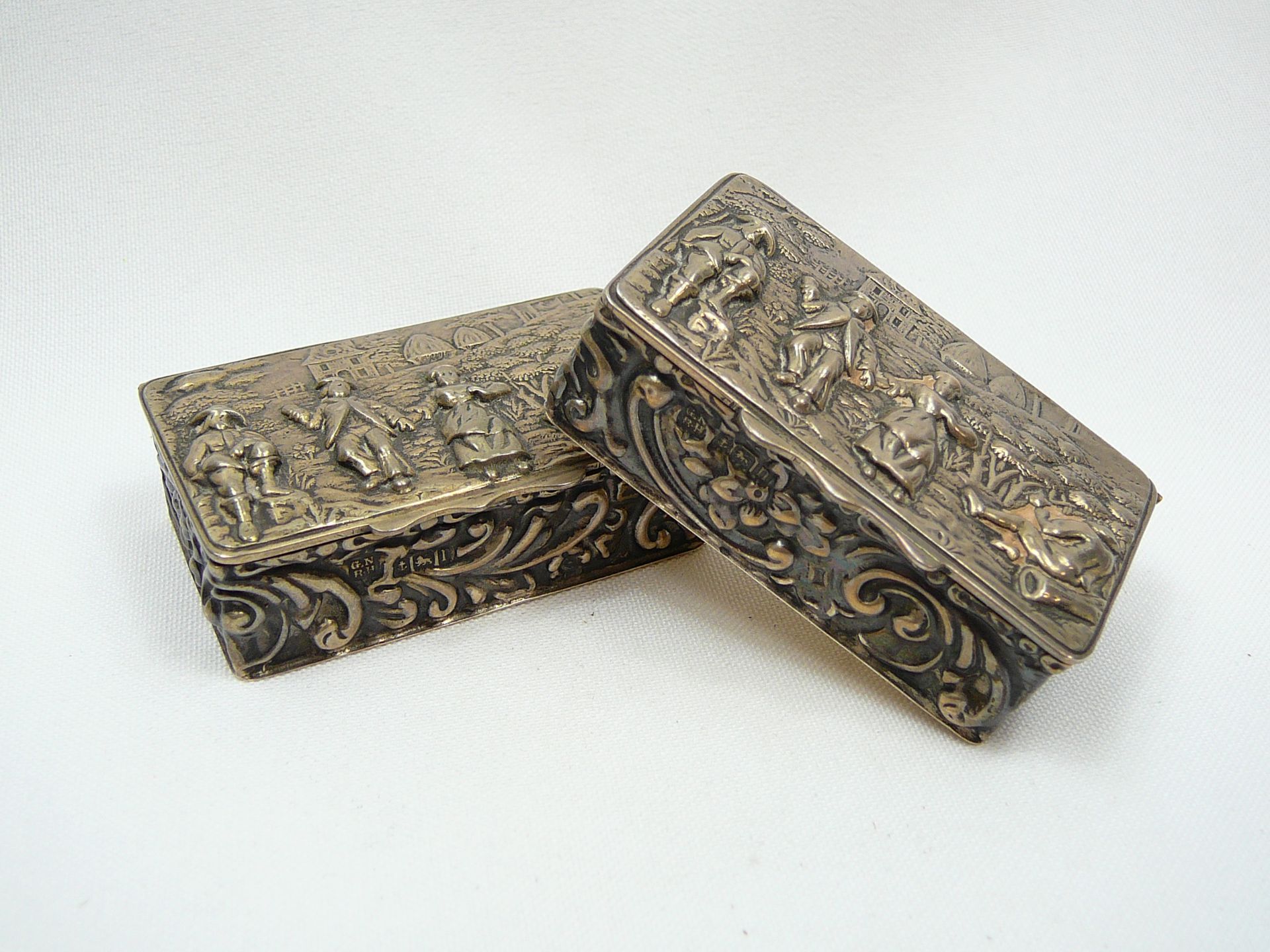 Pair of silver repousse snuff boxes