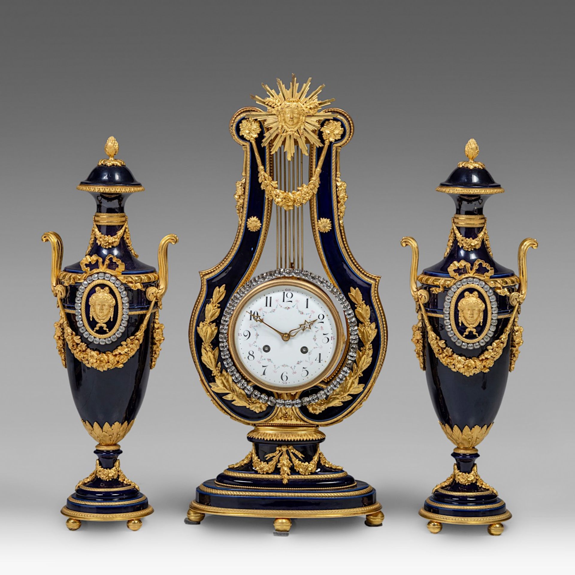 A fine Neoclassical three-piece cobalt blue porcelain and gilt bronze mounted clock set, H 55 - 65 c