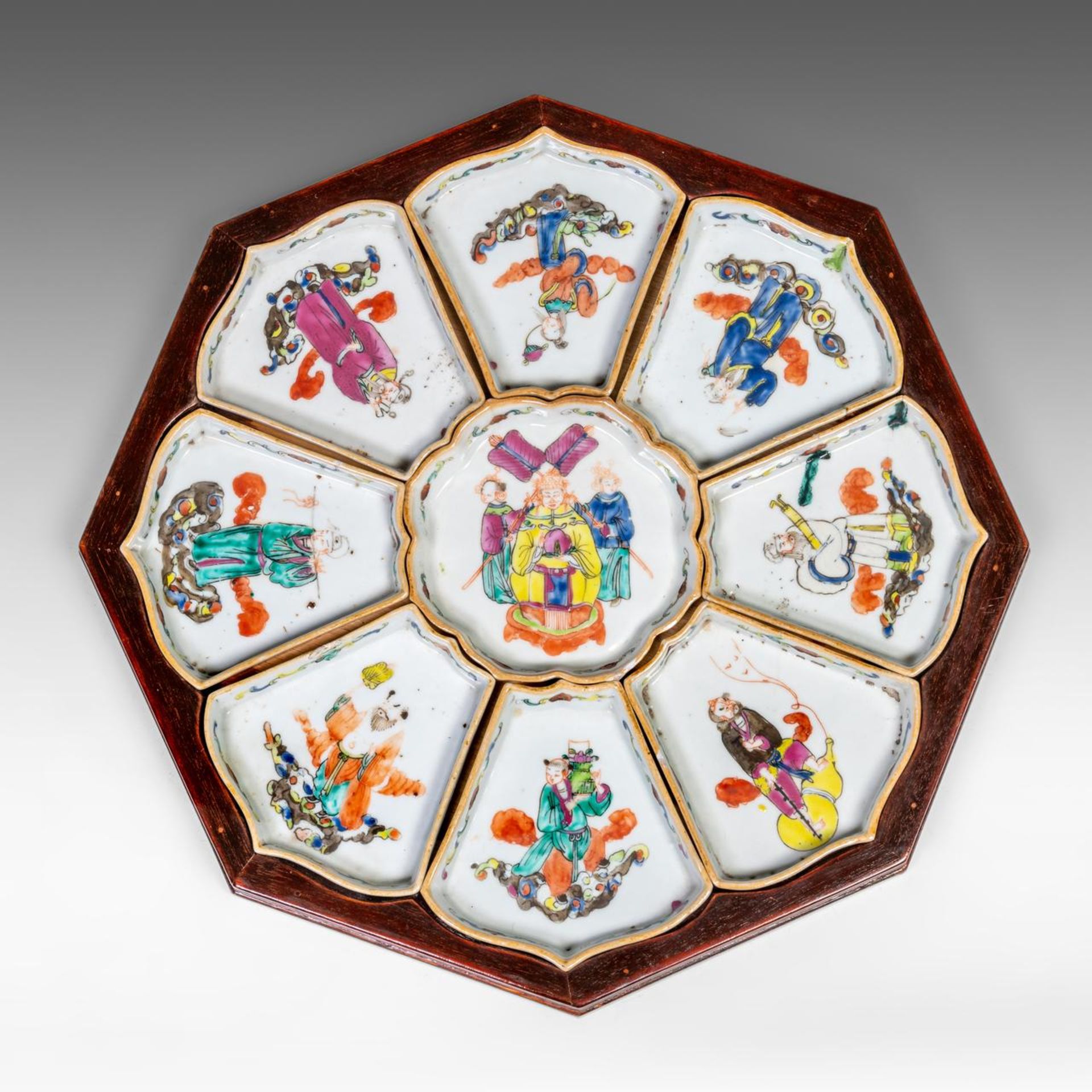 A complete set of Chinese famille rose 'Immortals' sweet meat dishes, fitted in a wooden tray, late