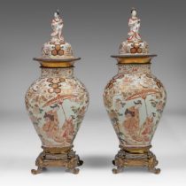 A fine and rare pair of Japanese Imari 'Lady and sunshade' vases and covers, the top and bottom with