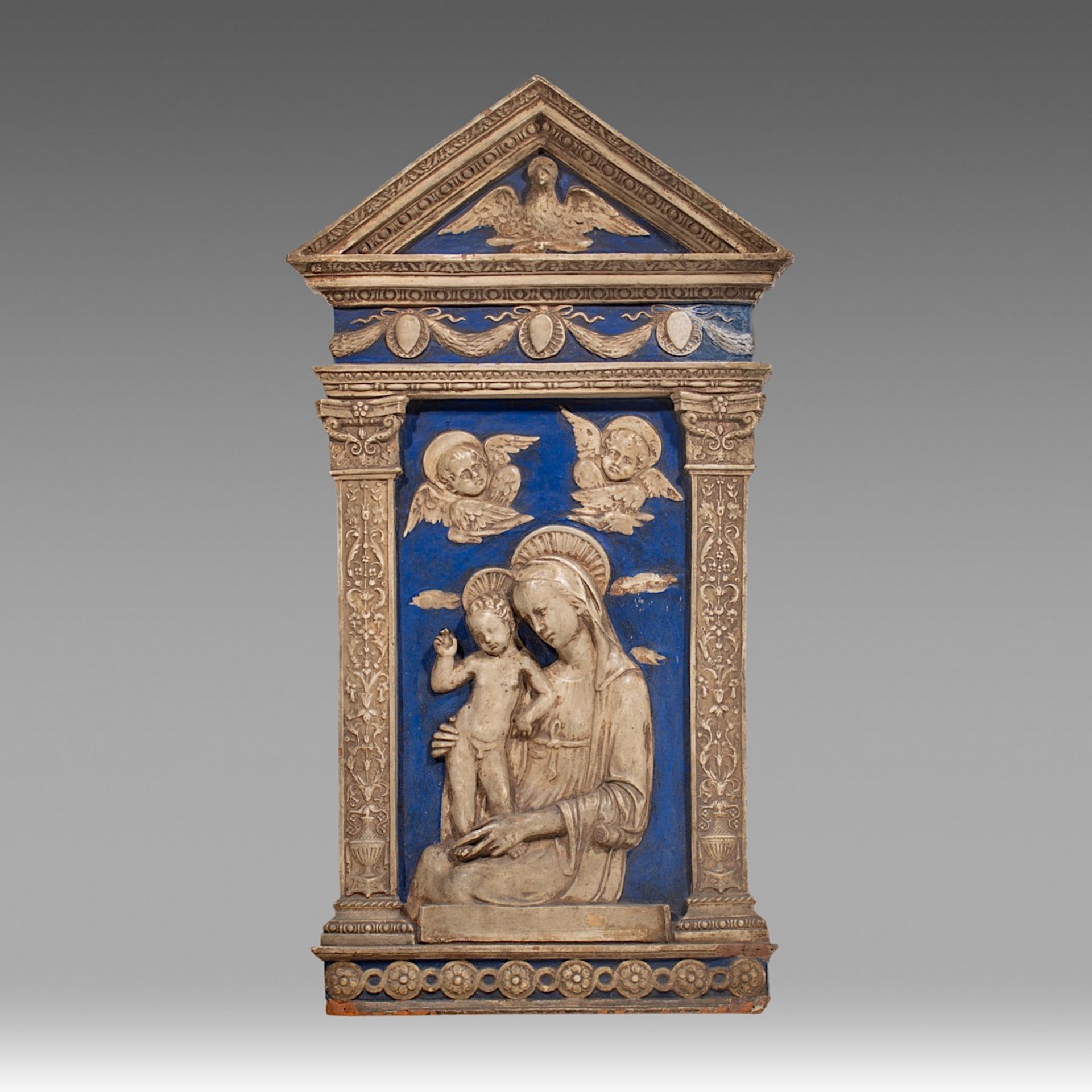 A blue and white glazed terracotta relief of the Virgin and Child in the Della Robbia manner or a fo