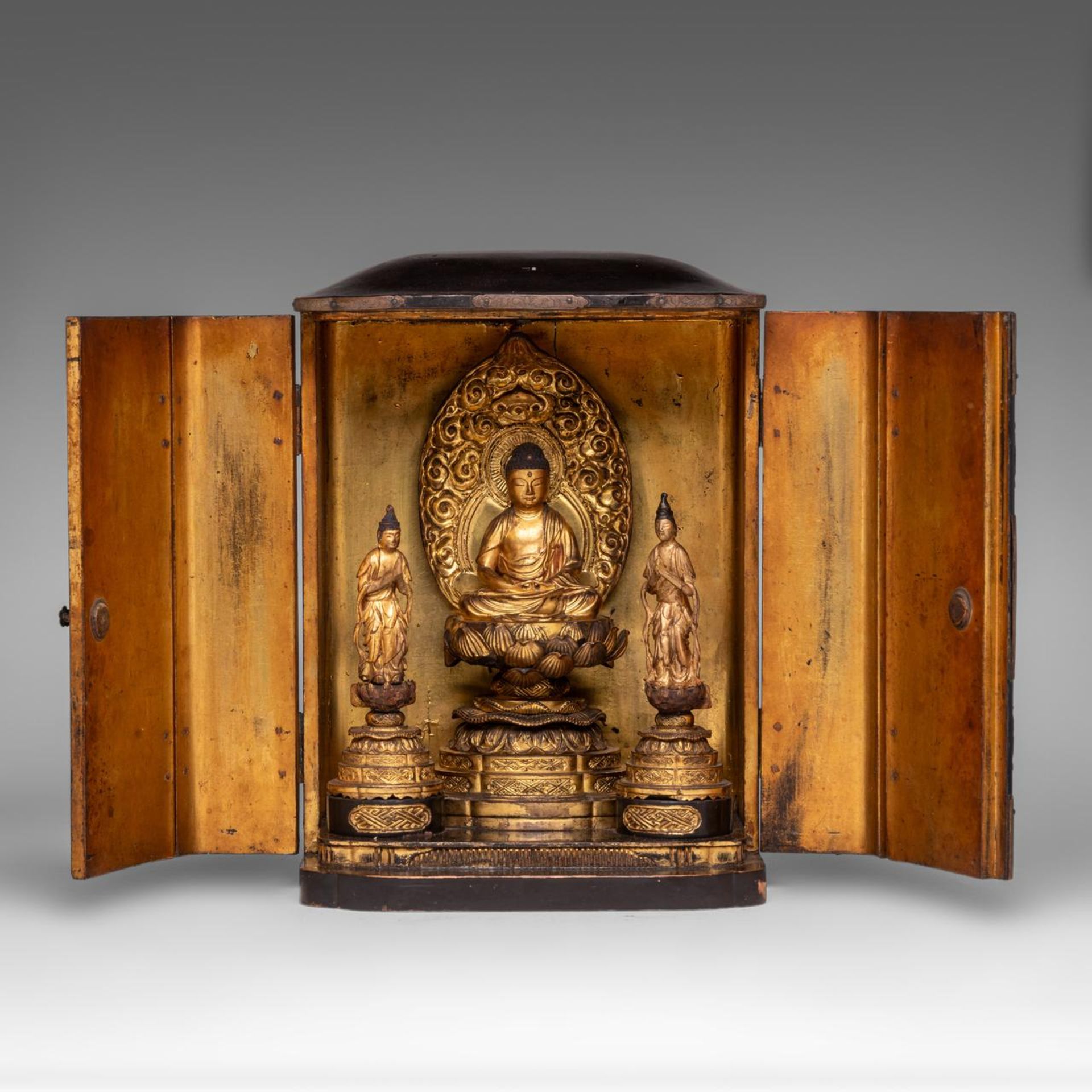 A Japanese lacquer zushi travelling shrine with seated Buddha Gautama and acolytes, late Edo period,