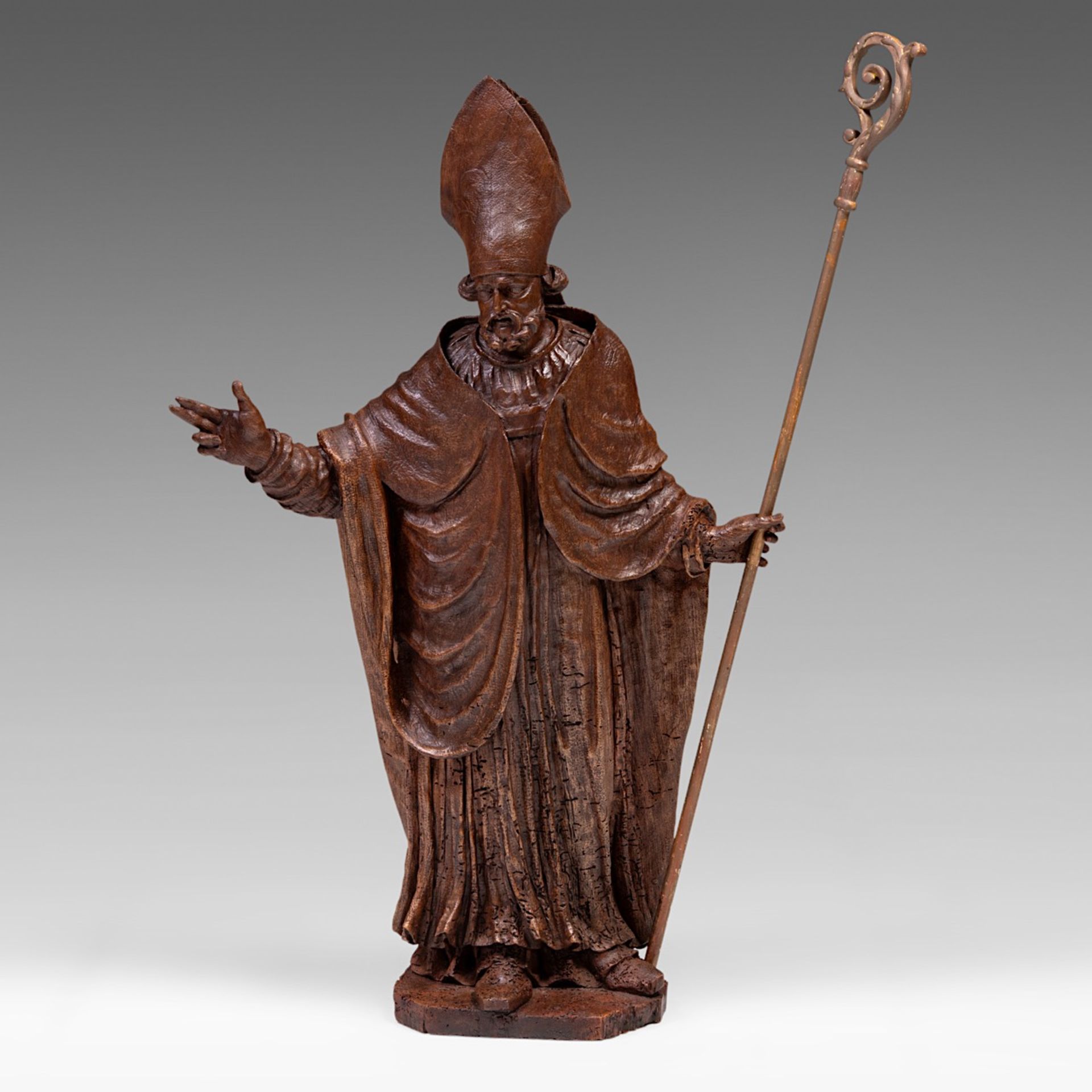 An 18thC carved oak sculpture of a bishop making his blessing, H 110 cm
