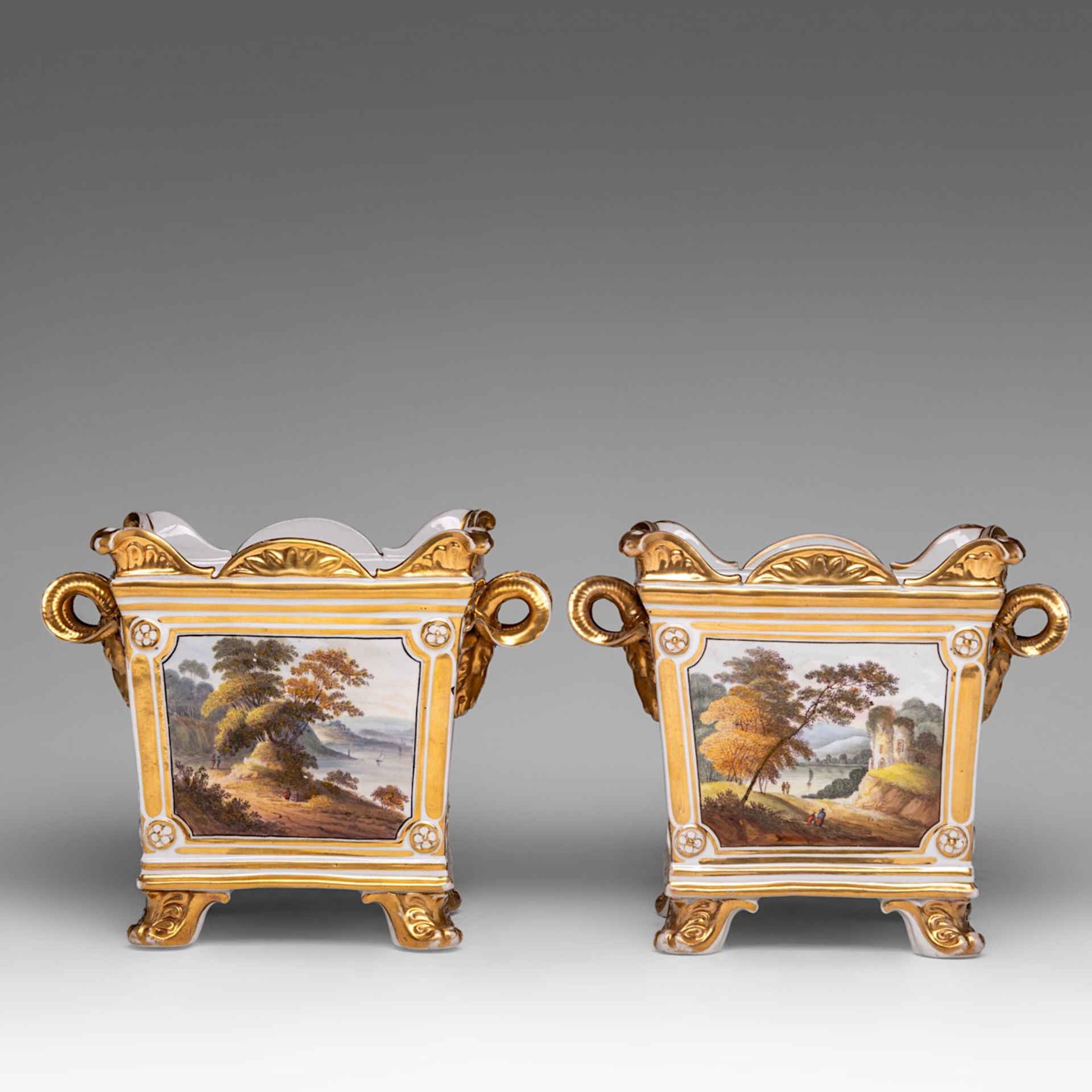 A pair of hand-painted and gilt-decorated porcelain jardinieres with landscapes and flowers, 19thC, - Bild 2 aus 7