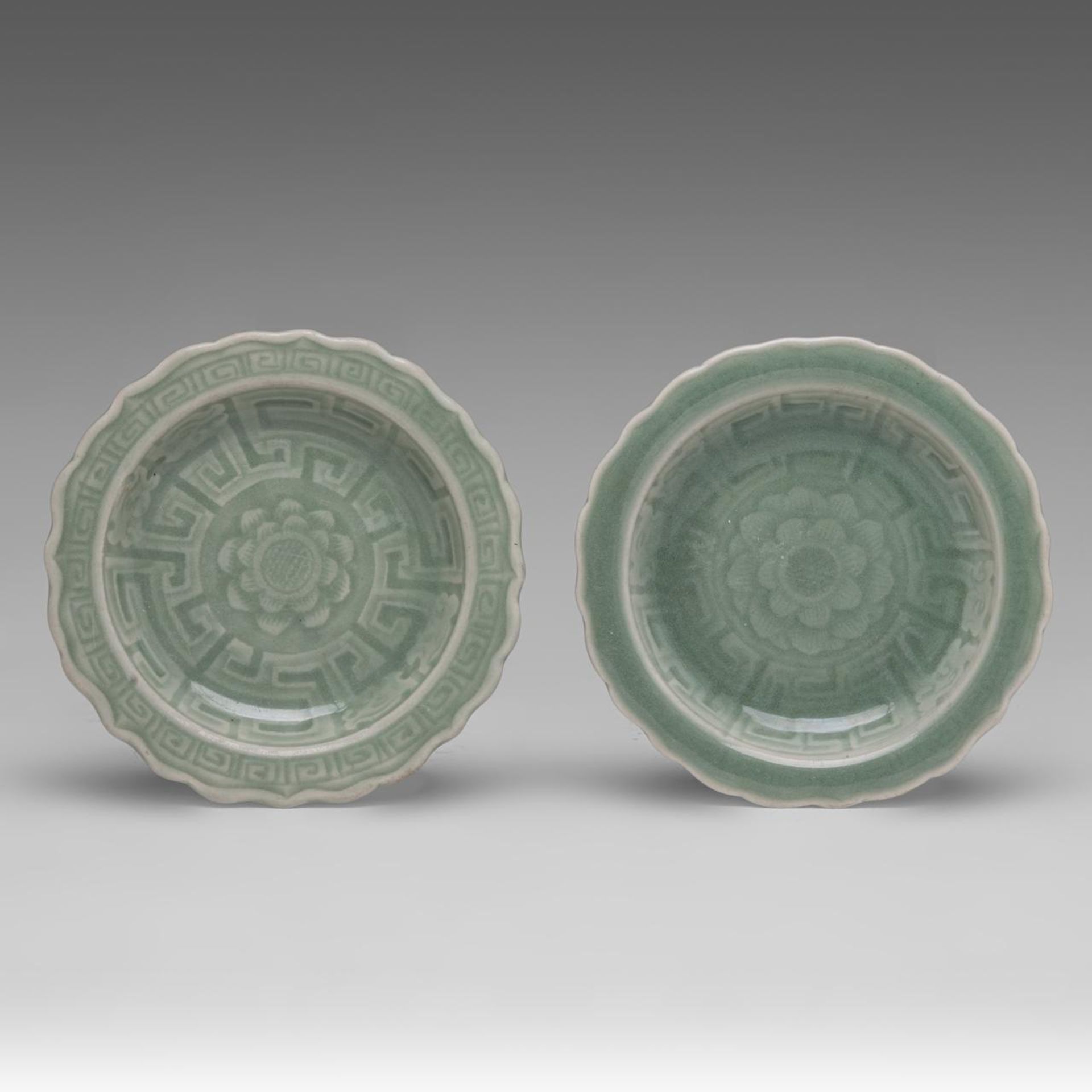 A pair of Chinese incised celadon ware 'Lotus' plates, 19thC, dia 12,7 cm