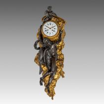 A Rococo style gilt and patined bronze cartel clock, with Chronos and a cherub, H 80 cm