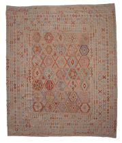 A large Oriental woollen Kilim rug, 381/385x321/318 cm