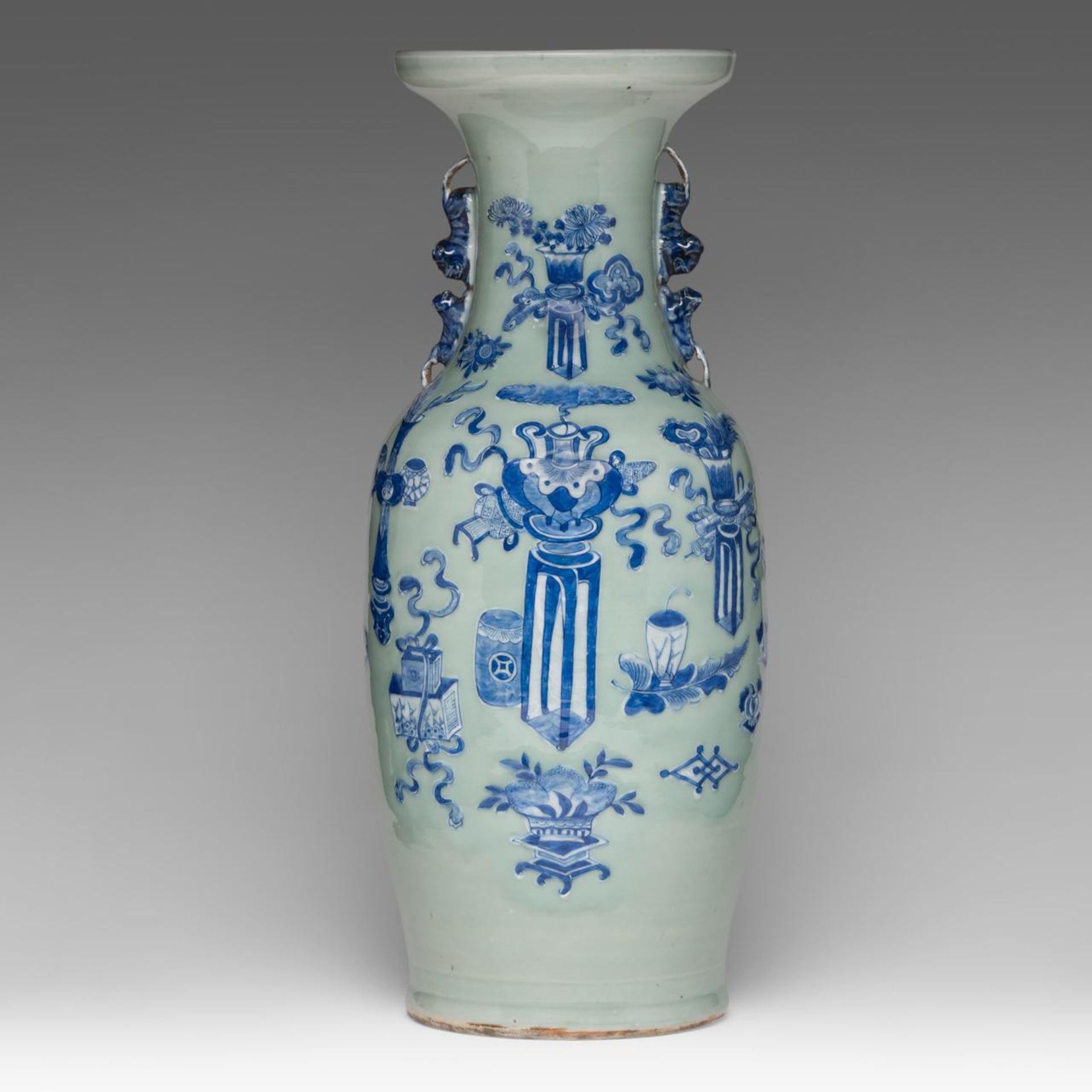 A Chinese blue and white on celadon ground 'One Hundred Treasures' vase, paired with lion handles, 1