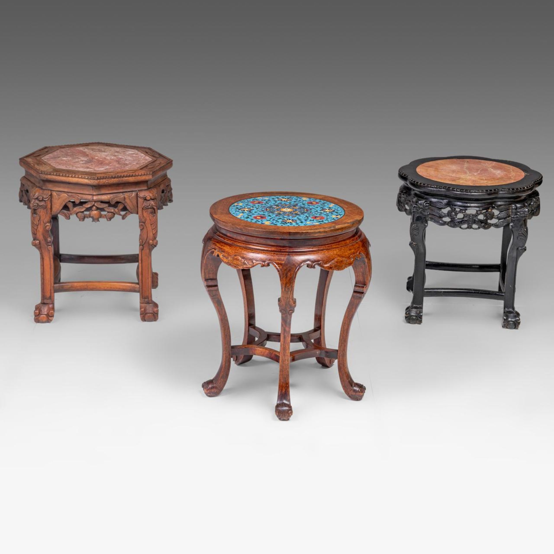 Three Chinese carved hardwood bases, two including a marble top, one with a cloisonne enamelled plaq