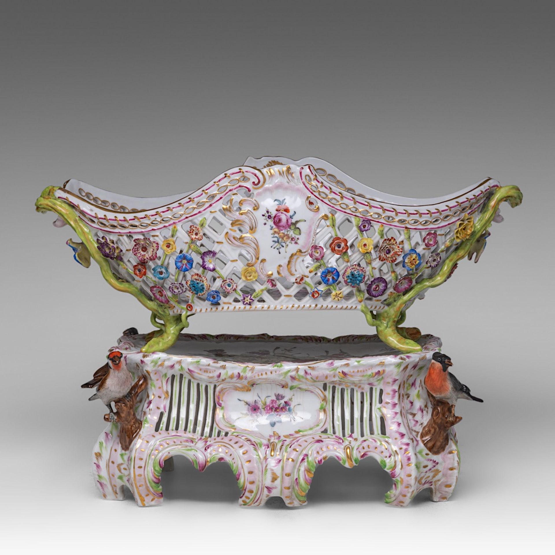 A polychrome Saxony porcelain basket on stand, decorated with modelled birds and flowers, H 33 - W 4
