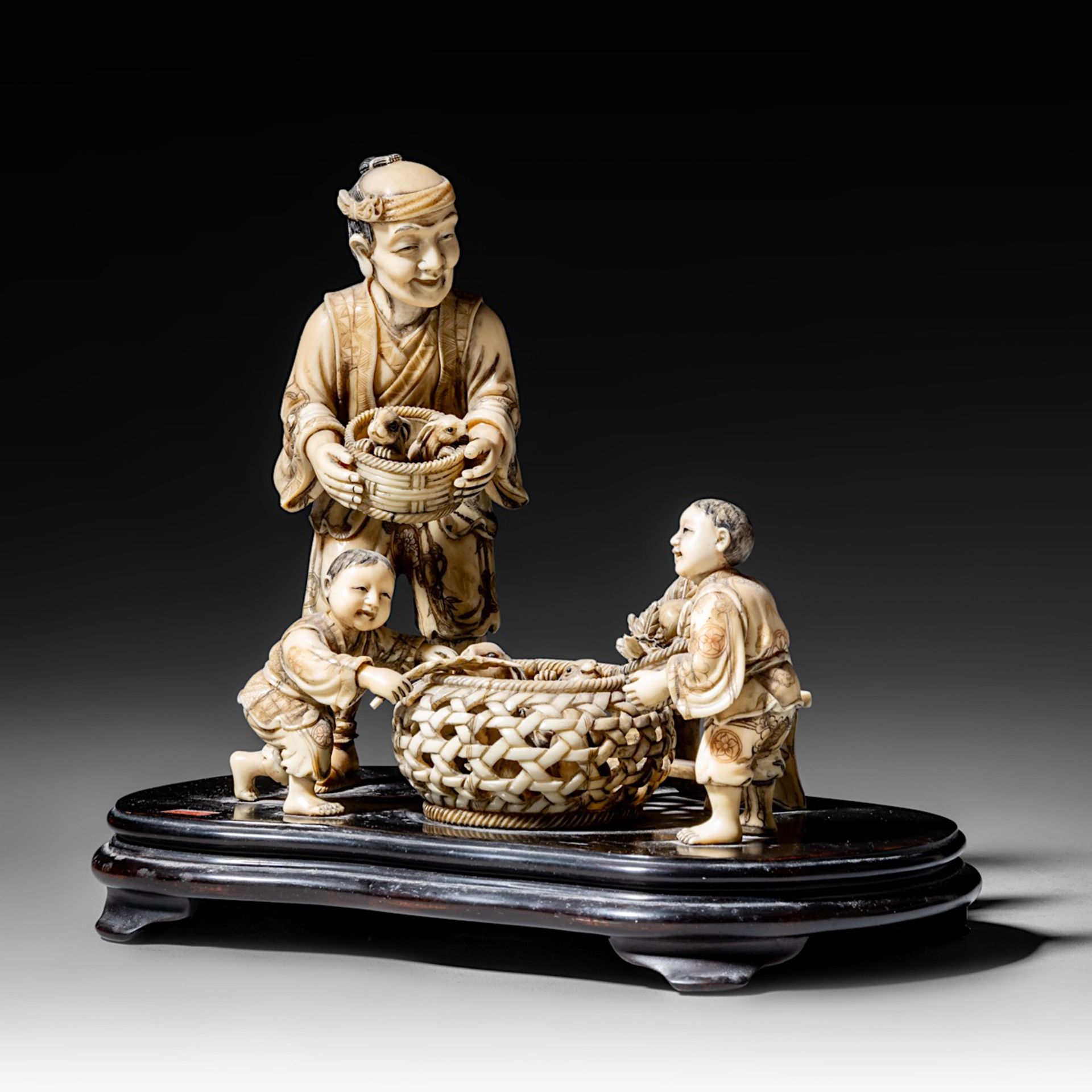A walrus/sperm whale ivory okimono group of a family with bunnies, fixed on a black lacquered wooden - Image 2 of 10