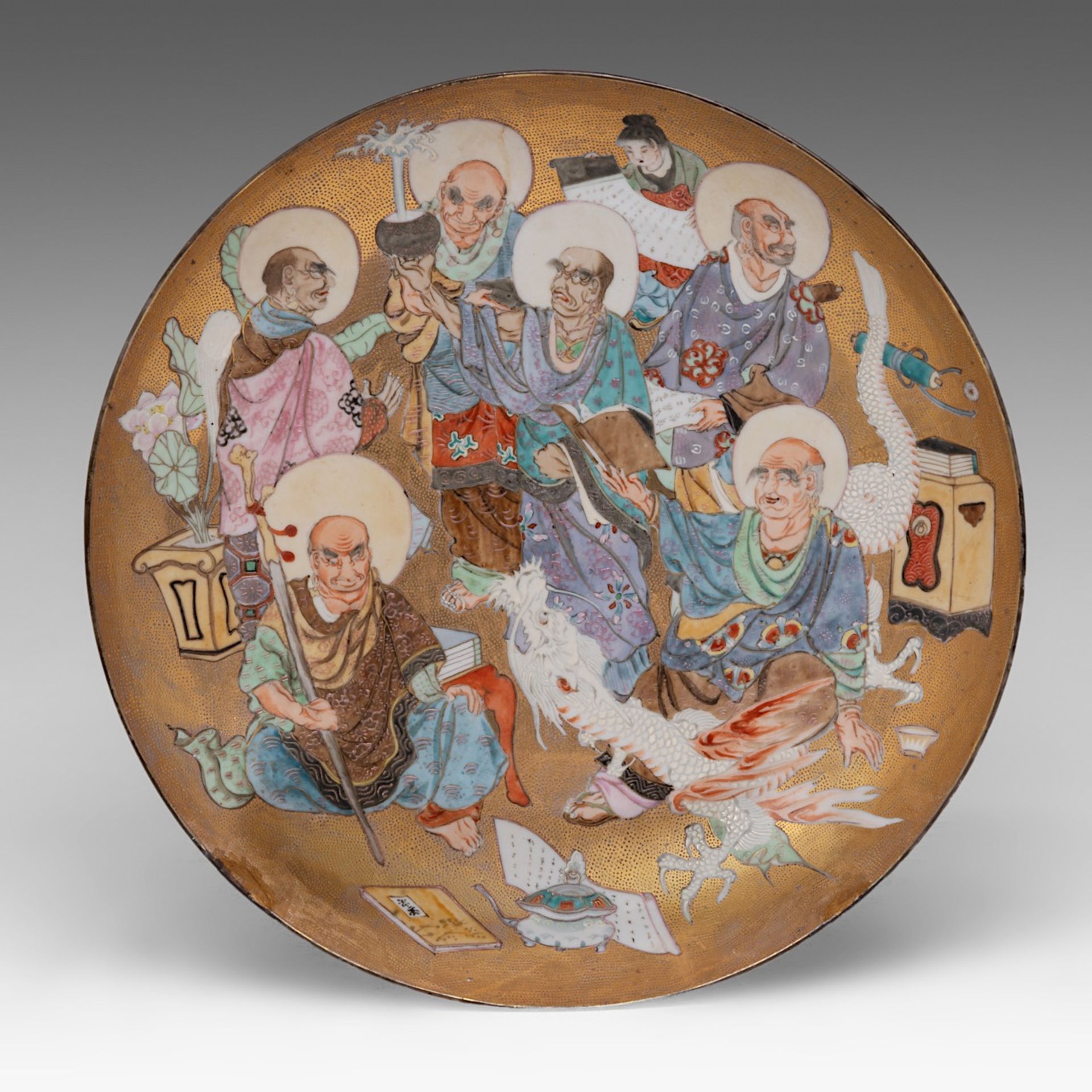 A remarkable Japanese Satsuma ware 'Arhats' plate on a lustrous gilt ground, late Meiji period (1868